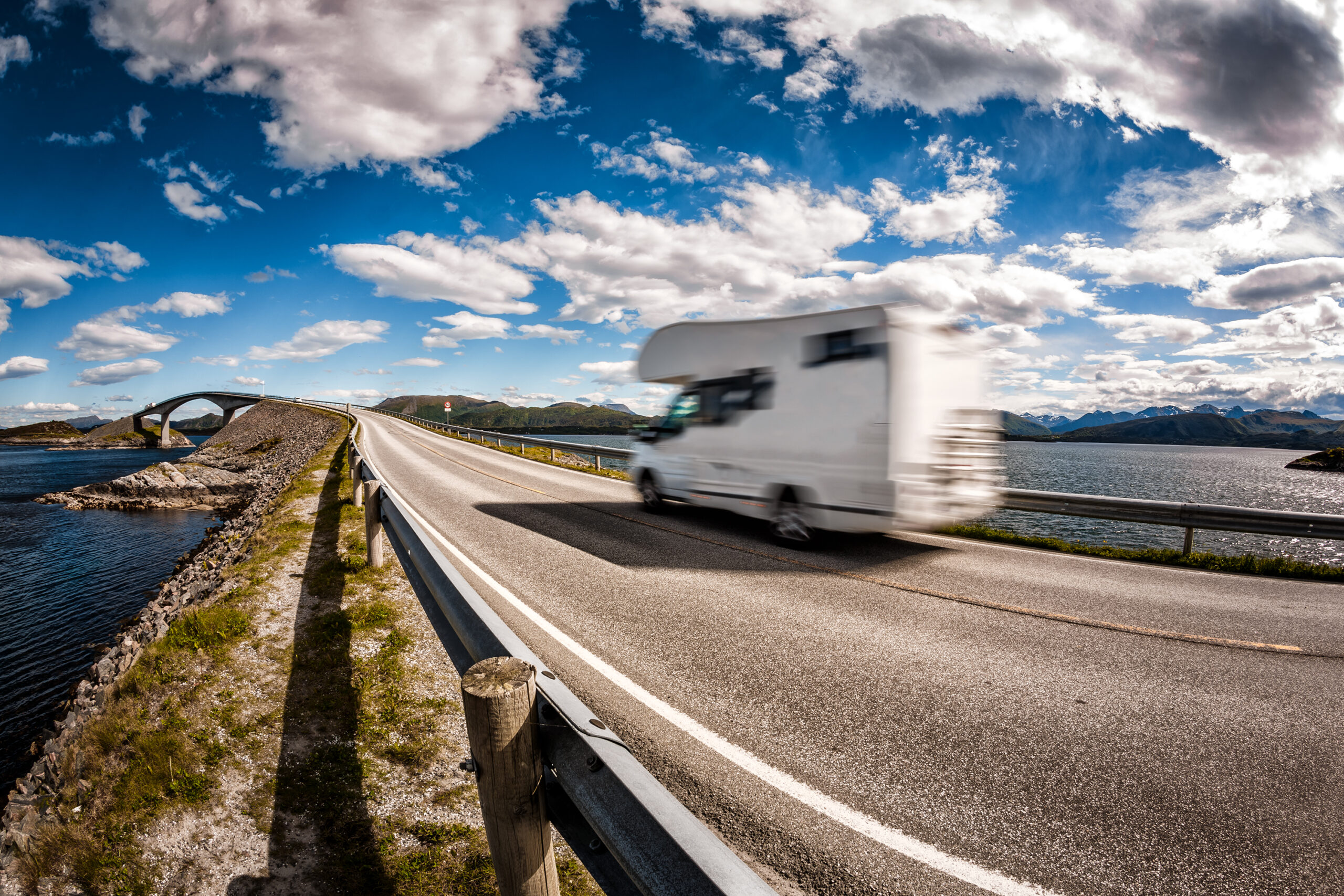 Caravan car RV travels on the highway Norway. Atlantic Ocean Road or the Atlantic Road (Atlanterhavsveien) been awarded the title as (Norwegian Construction of the Century).