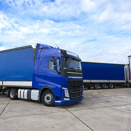 Truck vehicle with trailers in background.